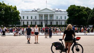 People gather on a section of Pennsylvania Avenue that was reopened to the public in front of the White House in Washington, DC.