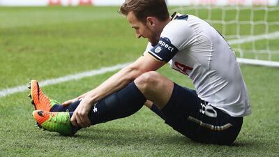 Harry Kane of Tottenham Hotspur holds his ankle before having to leave the field against Millwall on March 12, 2017 in London, England. Julian Finney / Getty Images