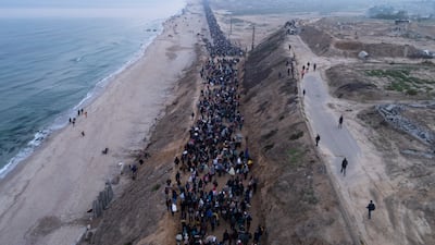 Thousands of Palestinians walked along Gaza's coastal road to return to their homes in the enclave's north on Monday, January 27. AP