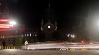 Mumbai's historic railway station Chhatrapati Shivaji Maharaj Terminus is seen in the background from the streets as lights were switched off for Earth Hour, in India. AP