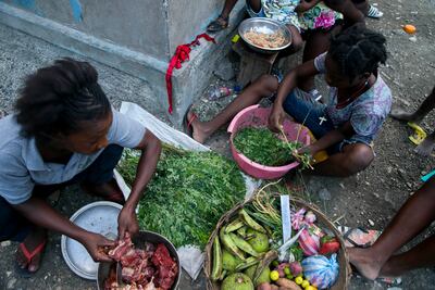 Street vendors ready ingredients to make joumou soup to sell in Port-au-Prince, Haiti, in December 2019. AP photo