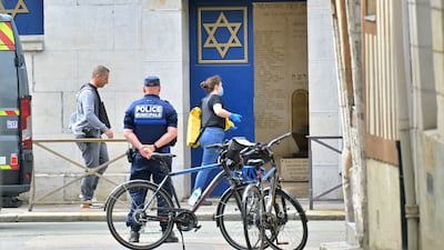 Police officers investigate at a synagogue in the Normandy city of Rouen where French police have killed earlier an armed man who was trying to set fire to the building. AFP