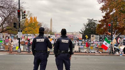 DC police officers stand in front of a fence surrounding Lafayette Square at Black Lives Matter plaza near the White House in Washington, DC. AFP