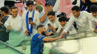 Al Hilal star Karim Benzema celebrates with fans after winning the King's Cup title in Jeddah. Reuters