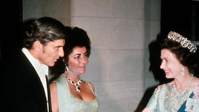 Queen Elizabeth ll meets Liz Taylor and husband John Warner at a gala dinner in 1976 in Washington. Getty Images