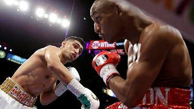 Amir Khan punches Devon Alexander during their welterweight bout Saturday, Dec. 13, 2014, in Las Vegas. (AP Photo/John Locher)