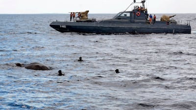 Sri Lanka Navy divers try to tie a rope around an elephant who had strayed away into the open sea and trying to stay afloat off the east coast of the Island. EPA
