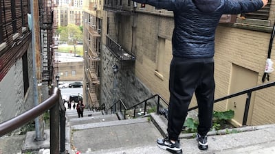 Patricio Osuna, a tourist from Tijuana, Mexico, poses at the top of the 'Joker' steps in the Bronx borough of New York, US, on Wednesday, October 16, 2019. Reuters