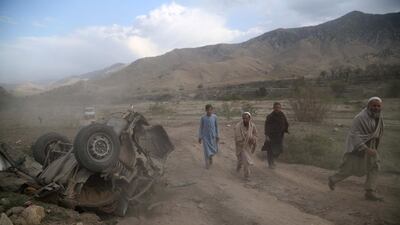 People survey the scene of a road side bomb blast in Achin district of Nangarhar province, Afghanistan, 21 October 2018. EPA