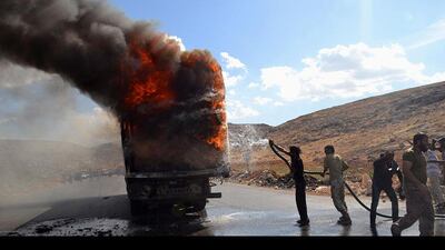 Firefighters try to put out a fire at the site of an explosion on the Syrian-Turkish border crossing of Bab al-Hawa in Harem, Syria. Amer Alfaj / Reuters