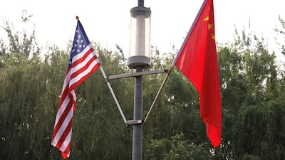 National flags of China and the United States hang from a pole on a road ahead of U. S. President Donald Trump's state visit to China, in Beijing, China, May 13, 2026. REUTERS / Tingshu Wang