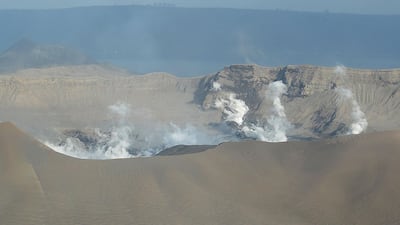 White steam emits from Taal volcano crater as seen from a Philippine airforce helicopter during an aerial survey. Ted Aljibe / AFP
