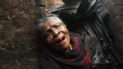 A female slum dweller cries in front of her destroyed home after a fire on February 11, 2014, gutted about 200 shanties at a slum in Mirpur, Dhaka, Bangladesh. There were no casualties reported, and the cause of the fire is unknown. Abir Abdullah / EPA