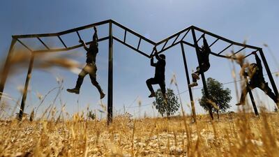 Iraqi Kurdish Peshmerga fighters take part in a training session in the grounds of their camp in Arbil, the capital of the autonomous Kurdish region of northern Iraq. Karim Sahib / AFP