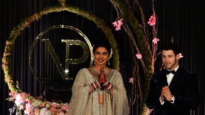 Newlyweds Priyanka Chopra, 36, and Nick Jonas, 26, pose for a photograph during a reception at a hotel in New Delhi on December 4, 2018. Photo: AFP
