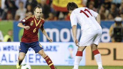 Playing at smaller venues owned by the little clubs of Spanish football gives national team members such as midfielder Andres Iniesta, left, a chance to repay those clubs they got their start with. Jose Jordan / AFP