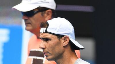 Rafael Nadal during practice alongside coach and uncle Toni Nadal. Julian Smith / EPA