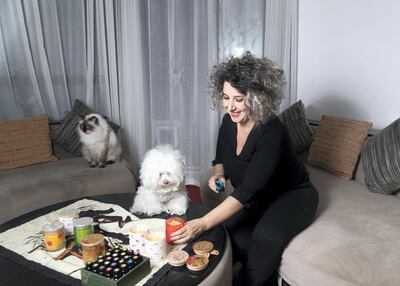 Claude Hachache makes pet-friendly candles at home as gifts. Reem Mohammed/The National