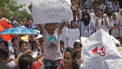 A boy holds a placard while joining a protest of hundreds of Bangladeshi students during a rally demanding safe roads on the seventh consecutive day of protests, in Dhaka city, Bangladesh. EPA / MONIRUL ALAM