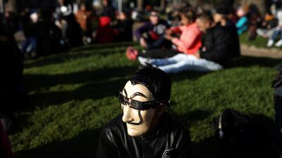 A man wears a mask and a pair of eclipse glasses to observe a solar eclipse at La Serena, Chile. Reuters