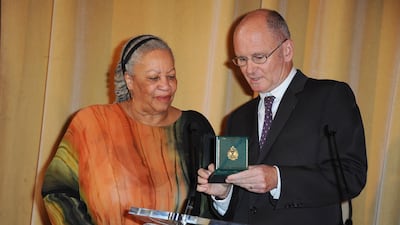 Morrison, left, receives the Honor Medal of The City of Paris (Grand Vermeil) from Christophe Girard at Mairie de Paris in 2010. Getty Images