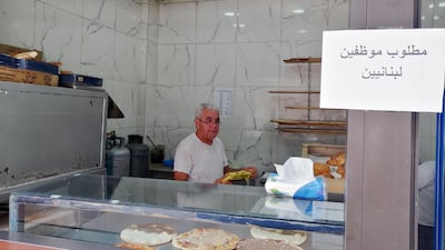 Saeed Abdallah Mussa, 59, working at his bakery in Beirut adorned with a sign that reads “we want Lebanese employees”. Sunniva Rose / The National