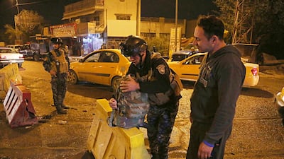Iraqi security forces working at the scene of a suicide bombing in Baghdad, Iraq on January 14, 2018. Karim Kadim / AP