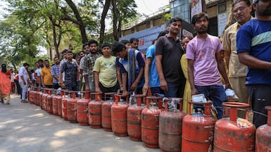 People queue to refill liquefied petroleum cylinders near a gas agency office in Mumbai, India. EPA