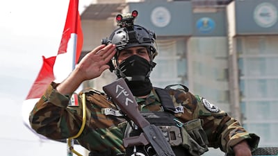 An Iraqi security officer salutes while taking part in a convoy celebrating the complete withdrawal of US troops from Iraq. EPA