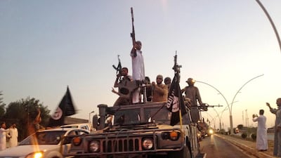 ISIL militants parade in a commandeered Iraqi security forces armored vehicle in Mosul. Photo: AP