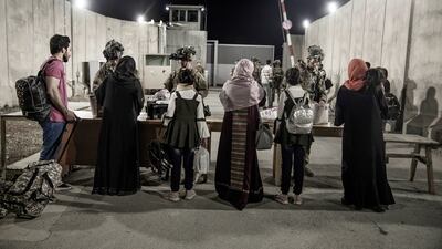 US soldiers check people seeking to fly out of Kabul airport. US Marine Corps