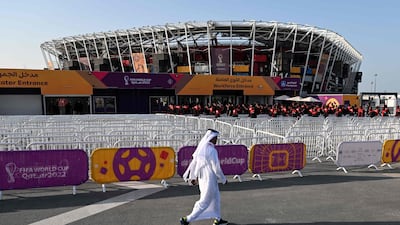 A man walks past the Stadium 974 in Doha on November 15, 2022, ahead of the Qatar 2022 World Cup football tournament. (Photo by Kirill KUDRYAVTSEV / AFP)