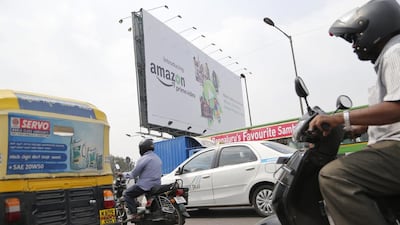 Motorists ride past a hoarding advertising Amazon Prime in Bengaluru. India’s foreign minister has demanded an apology from online retail giant Amazon.com for selling doormats depicting the Indian flag. Aijaz Rahi / AP Photo