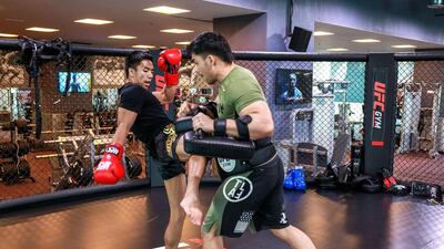 Greg “Thunderboy” Lorenzo, left, practising Muay Thai kicks with Amit Thapa at UFG Gym. Victor O Besa for The National