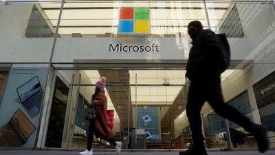 People walk past a Microsoft store in the Manhattan. The company reported a 17 per cent increase in the last quarter's revenue to $43.1 billion. Reuters