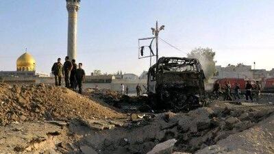 A photo released by the state-run Syrian Arab News Agency (SANA) shows Syrian soldiers inspecting the site of a car bomb in the Sayyida Zeinab suburb of Damascus yesterday.