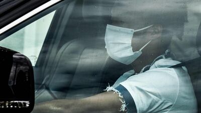 Juventus' Colombian midfielder Juan Cuadrado, wearing a face mask, arrives in his car. AFP