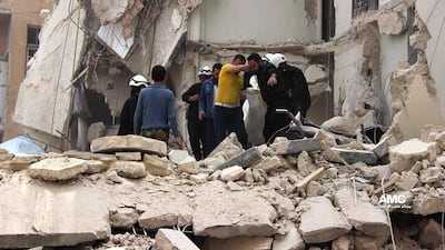 Rescue workers carry the body of a victim of a Syrian government airstrike, in Aleppo on April 12. AP