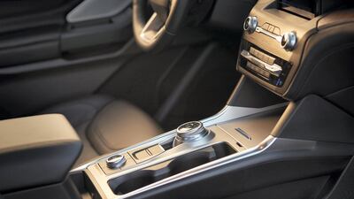 Interior features include a 980-watt, 12-speaker B&O premium audio system, a heated and power-adjustable steering wheel, and adaptive cruise control