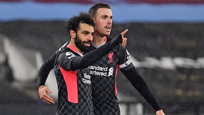 Liverpool's Mohamed Salah celebrates with teammate Jordan Henderson after scoring their second goal. AFP