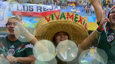 Mexican football fans cheer for their team during the Group A football match between Mexico and Cameroon at the Dunas Arena in Natal during the 2014 Fifa World Cup. Yuri Cortez / AFP
