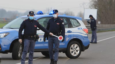 Italian police at the entrance to the small town of Casalpusterlengo, south-east of Milan, on Sunday, as Italy took drastic containment steps to fight the outbreak. EPA