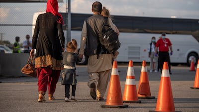 Afghan refugees who supported Canada's mission in Afghanistan prepare to board buses after arriving in Canada. Canadian Forces Combat Camera via Reuters