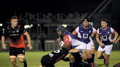 Jebel Ali Dragons, white, and Dubai Exiles, black, in action.