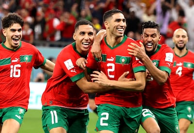 Moroccan players celebrate with Achraf Hakimi, centre, after he scored the last penalty kick which sent Morocco to the quarter-finals. EPA