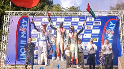 UAE's Rashed Al Qemzi and Mansoor Al Mansoori on the championship podium with Lithuania’s Edgaras Riabko