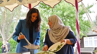 Meghan helps to prepare food at an event to mark the launch of a cookbook with recipes from a group of women affected by the Grenfell Tower fire, at Kensington Palace, in September 2018. Getty Images