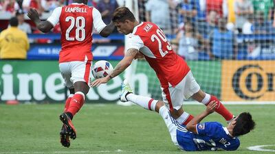 MLS All-Stars mid-fielder Mauro Diaz (R) falls to the ground while Arsenal forward Joel Campbell (L) and mid-fielder Granit Xhaka (C) compete for control of the ball during the MLS All-Star match against Arsenal at Avaya Stadium in San Jose, California on July 28, 2016. Josh Edelson / AFP