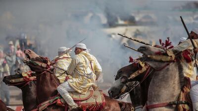 A troupe charges and fire their rifles during Tabourida, a traditional horse riding show also known as Fantasia, in the coastal town of El Jadida, Morocco.