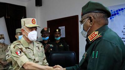 Egyptian military Chief of Staff Mohamed Farid shakes hands with his Sudanese counterpart Mohamed Othman al-Hussein after signing a bilateral agreement during a meeting of the Egyptian-Sudanese military committee, in Sudan's capital Khartoum. AFP